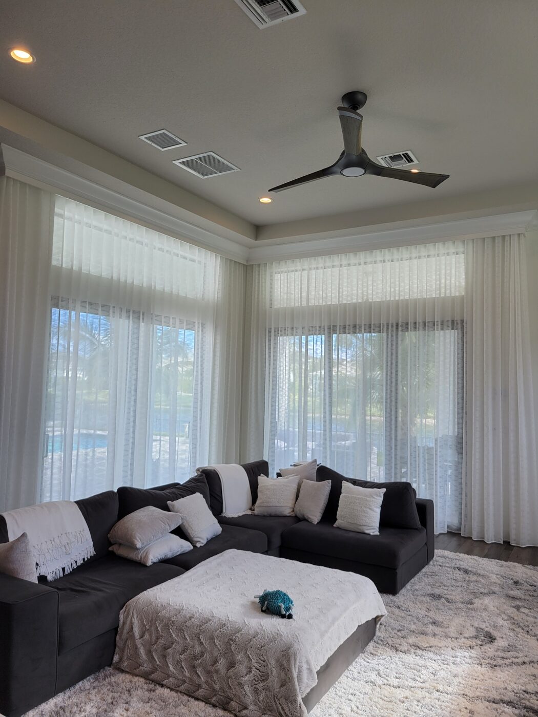 Floor-to-ceiling custom sheer draperies in a Palm Beach County living room