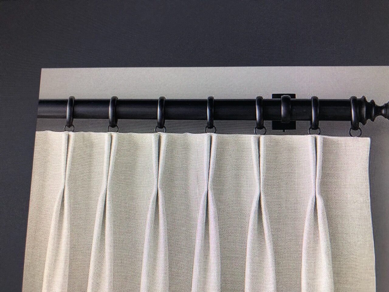 Alternate pinch-pleat drapery style installed on a decorative rod and rings